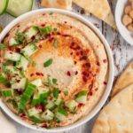 Roasted Garlic Hummus topped with Cucumbers served with pita