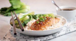 Easy Sweet and Sour Salmon served in a white bowl with box Choy and rice