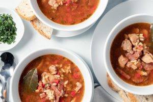 Puerto Rican Asopao Chicken and Rice Stew served in a white bowl with crackers and bread Meal Prep Meal Planning Counting Macros