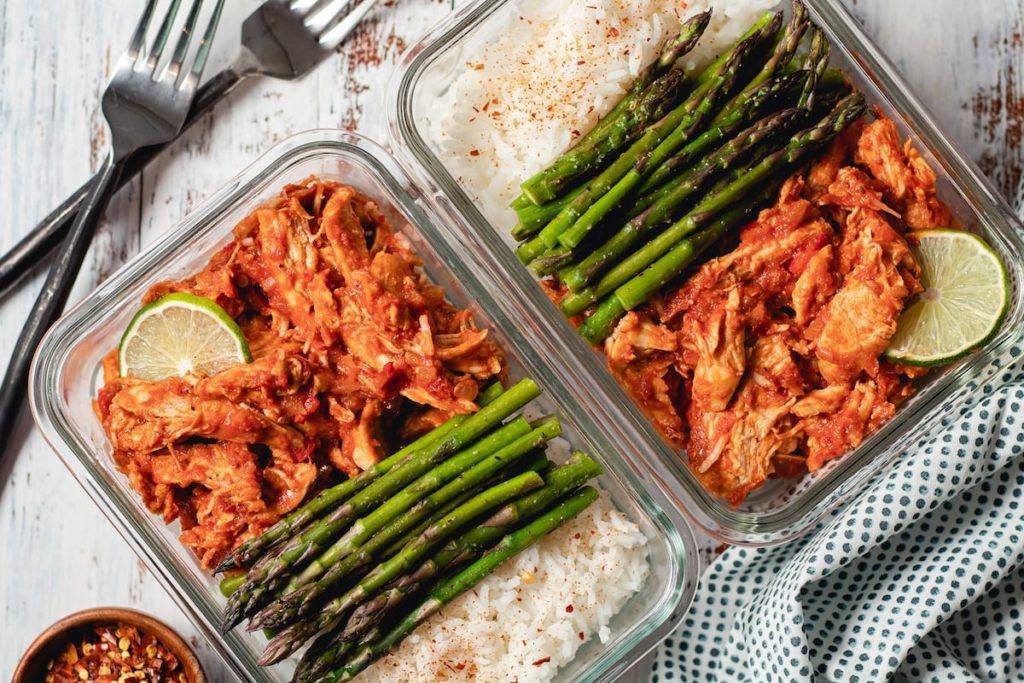 Spiced Tomato & Coconut Chicken w/Rice Served in a cast Iron Pan with a side of Asparagus Meal Planning Meal Prep Counting Macros Macro Friendly