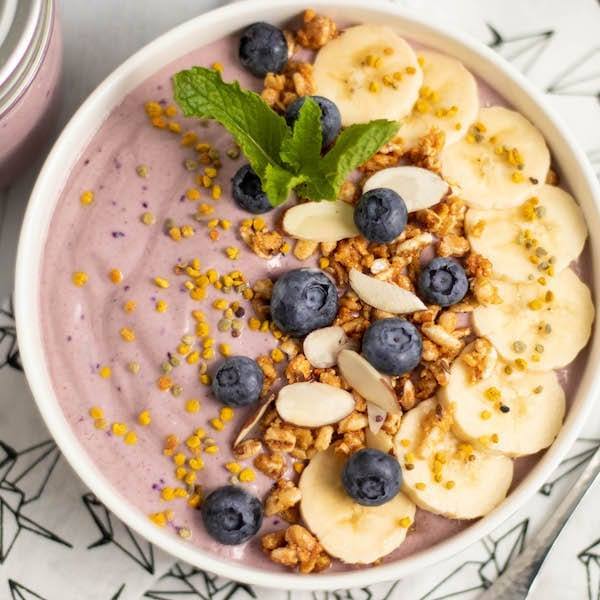 Acai Banana Smoothie Bowl toped with bee pollen, blueberries and bananas