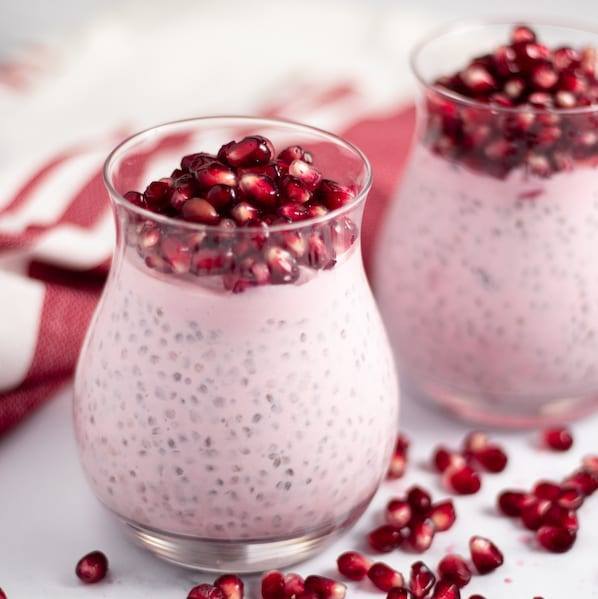 Pomegranate Chia Seed Parfait served in a small glass next to a red napkin