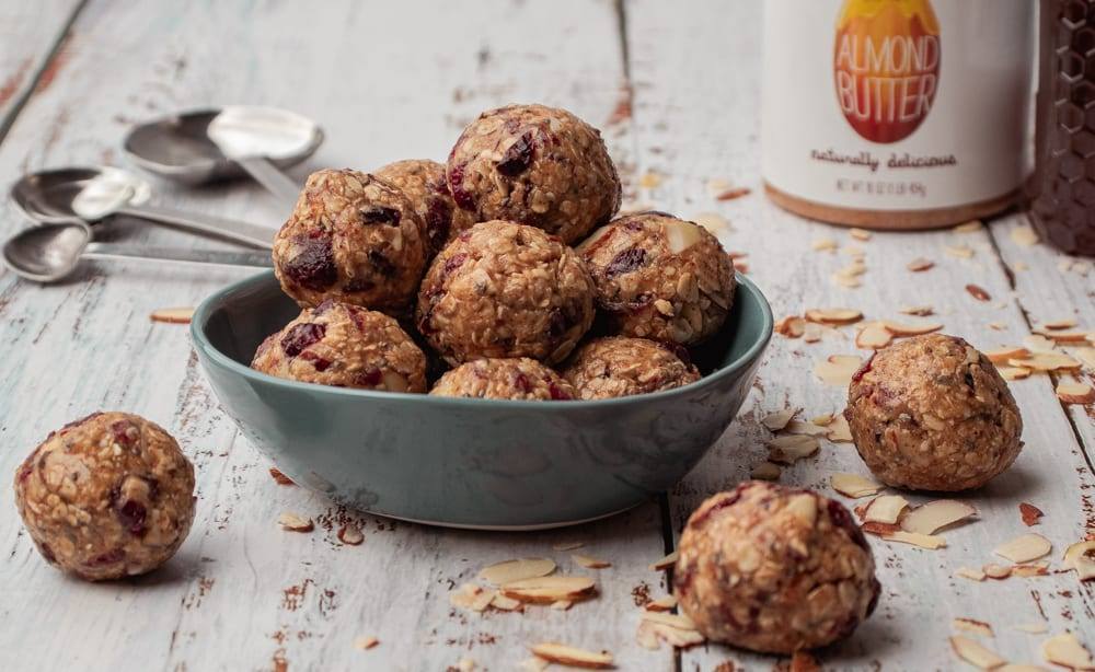 Cranberry Oatmeal Peanut Butter Bliss Balls in a blue bowl Meal Prep Meal planning Counting Macros Macro Friendly