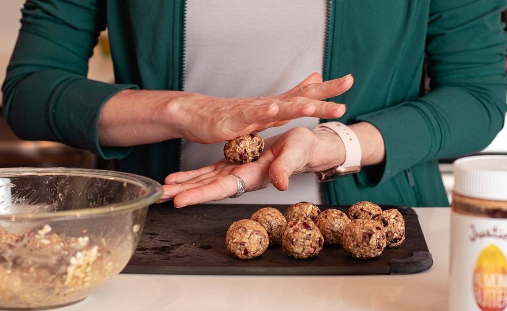 Cranberry Oatmeal Peanut Butter Bliss Balls in a blue bowl Cooking Healthy Recipes